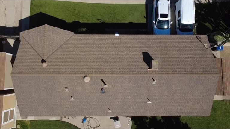 Aging shingle roof before replacement, aerial view