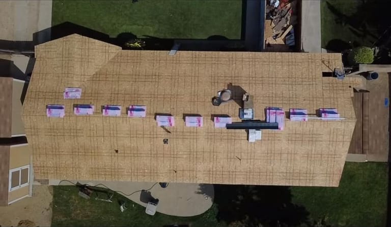 New roof deck and materials staged during a roof replacement