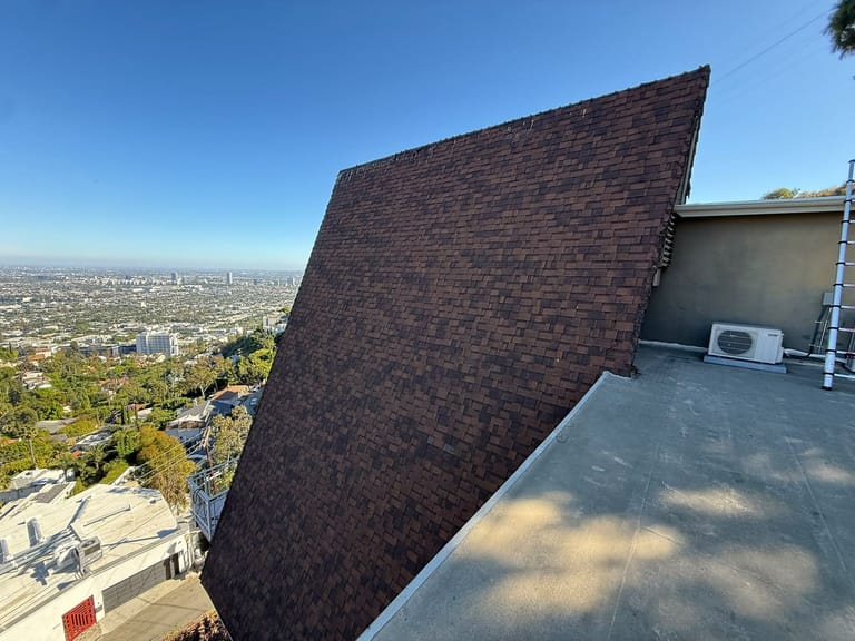 Brown shingle roof on a hillside home with a view over Los Angeles