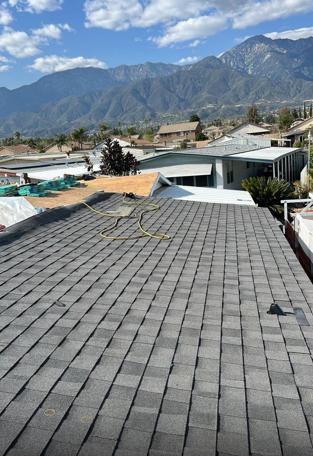 Finished architectural shingle roof with mountain backdrop